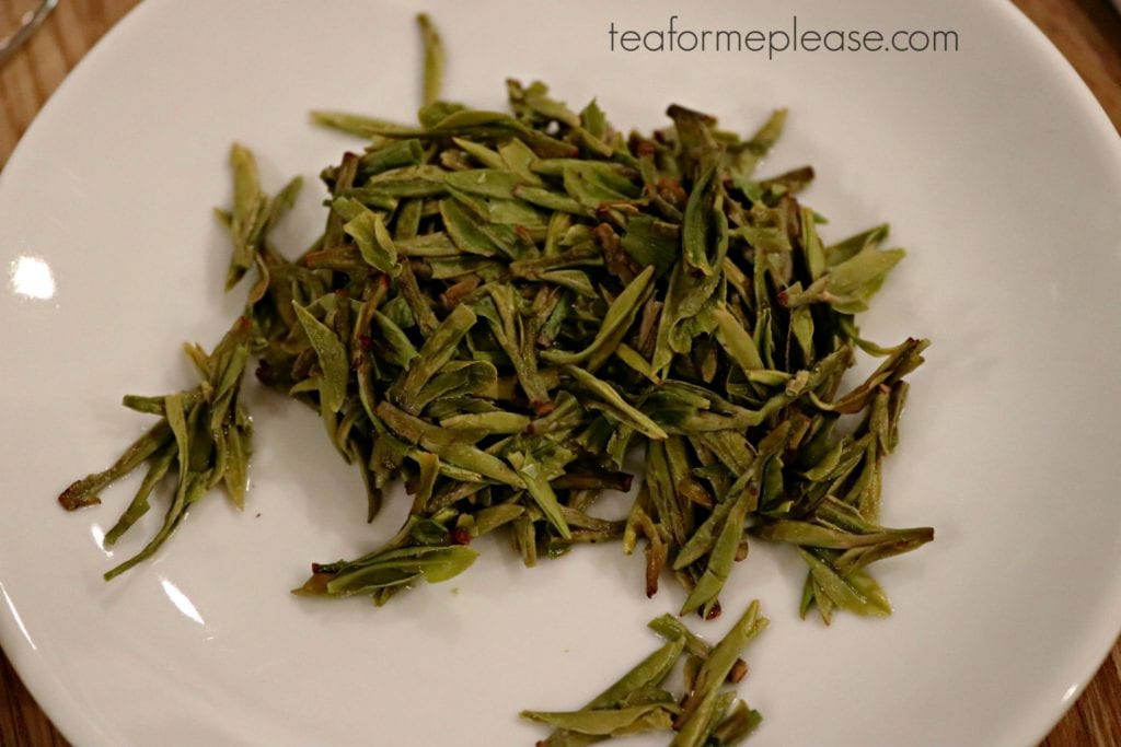 Wet green tea leaves