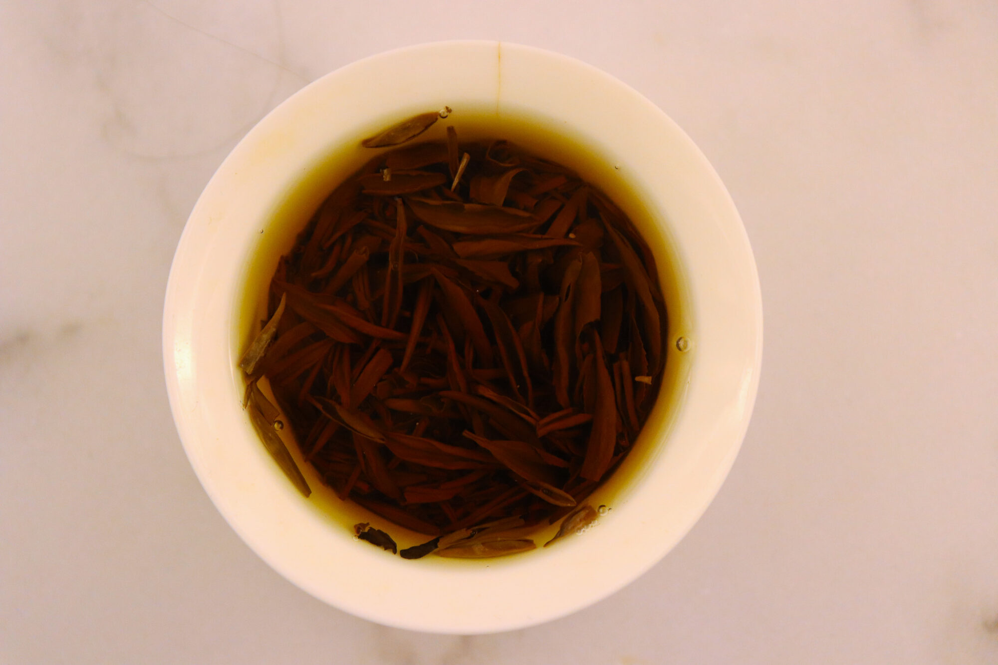 Little Red Cup Tea Co. Number One Black Special - Leaves in water in a gaiwan