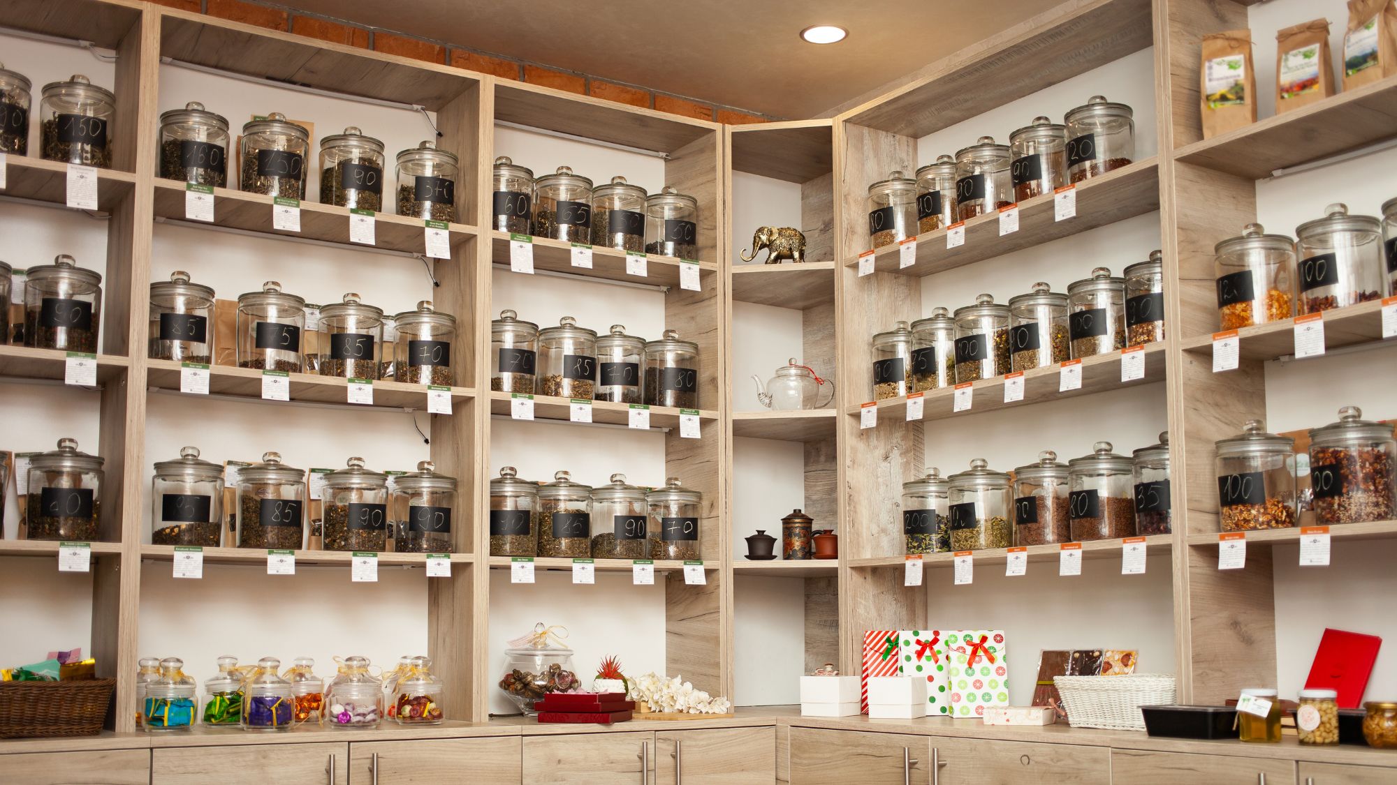 Jars of tea leaves on shelves - 8 Things You Should Do Before Starting a Tea Business