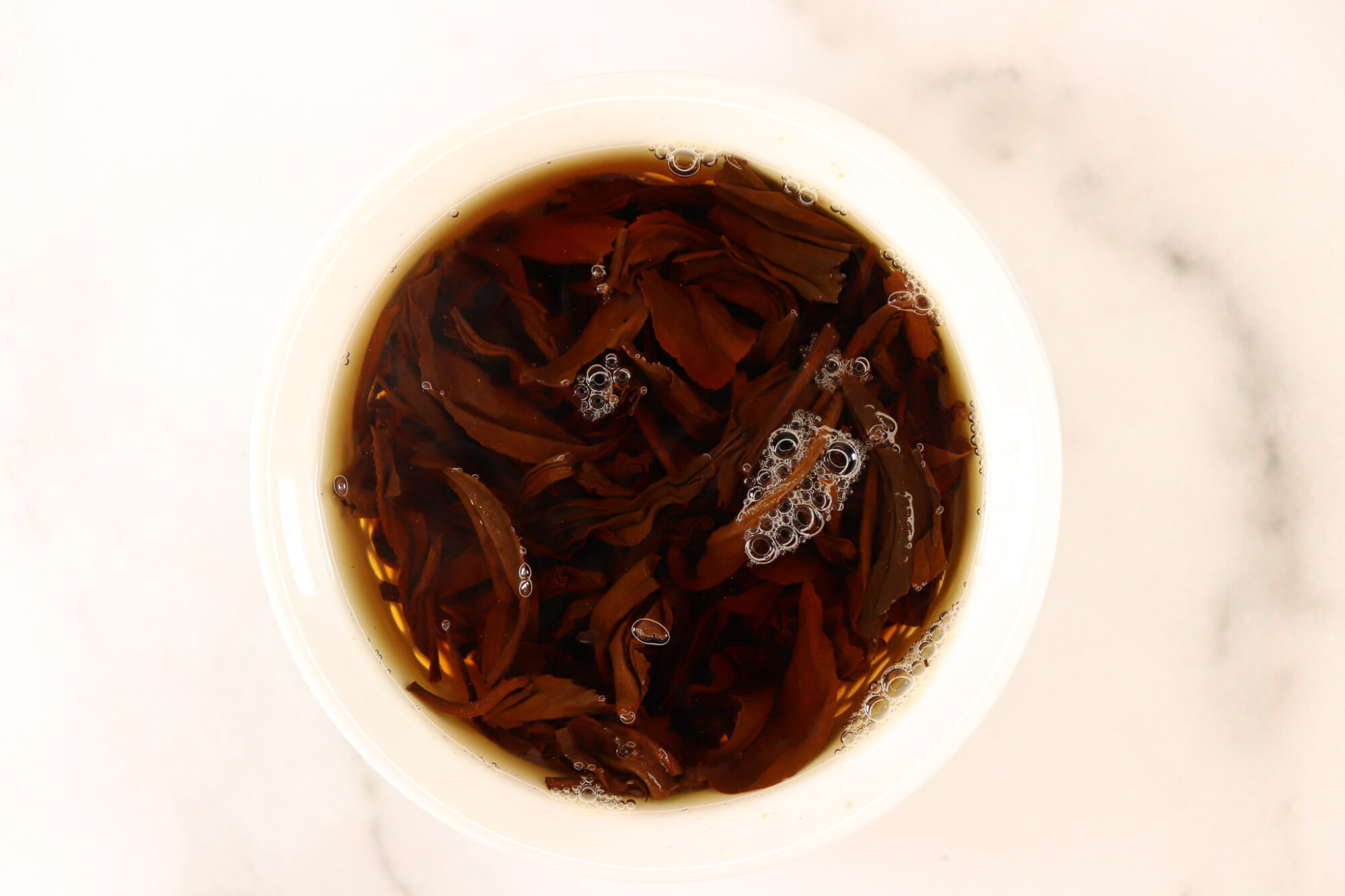 Crimson Lotus Tea Roam - leaves brewing in a gaiwan