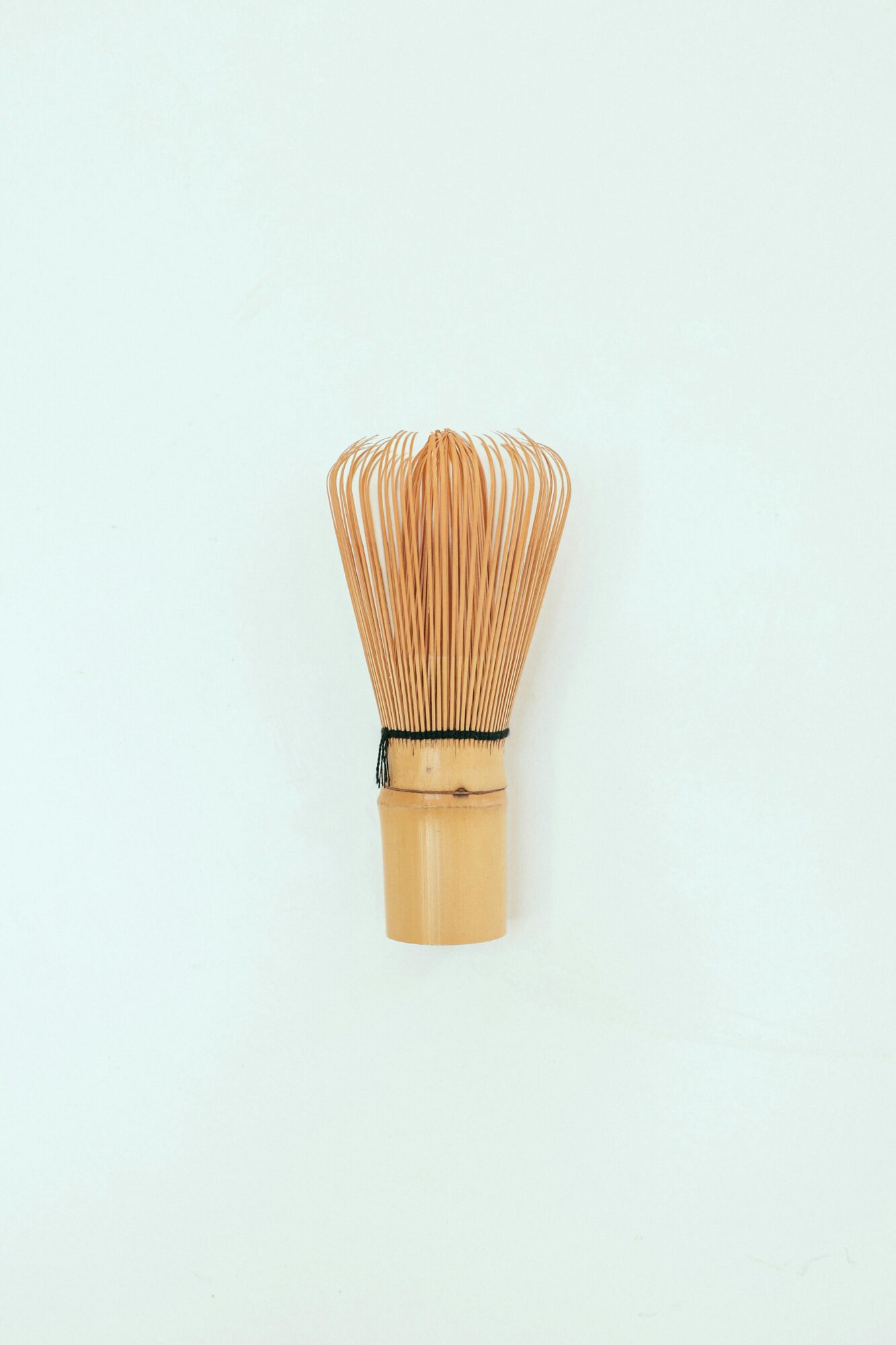bamboo matcha whisk on a white background