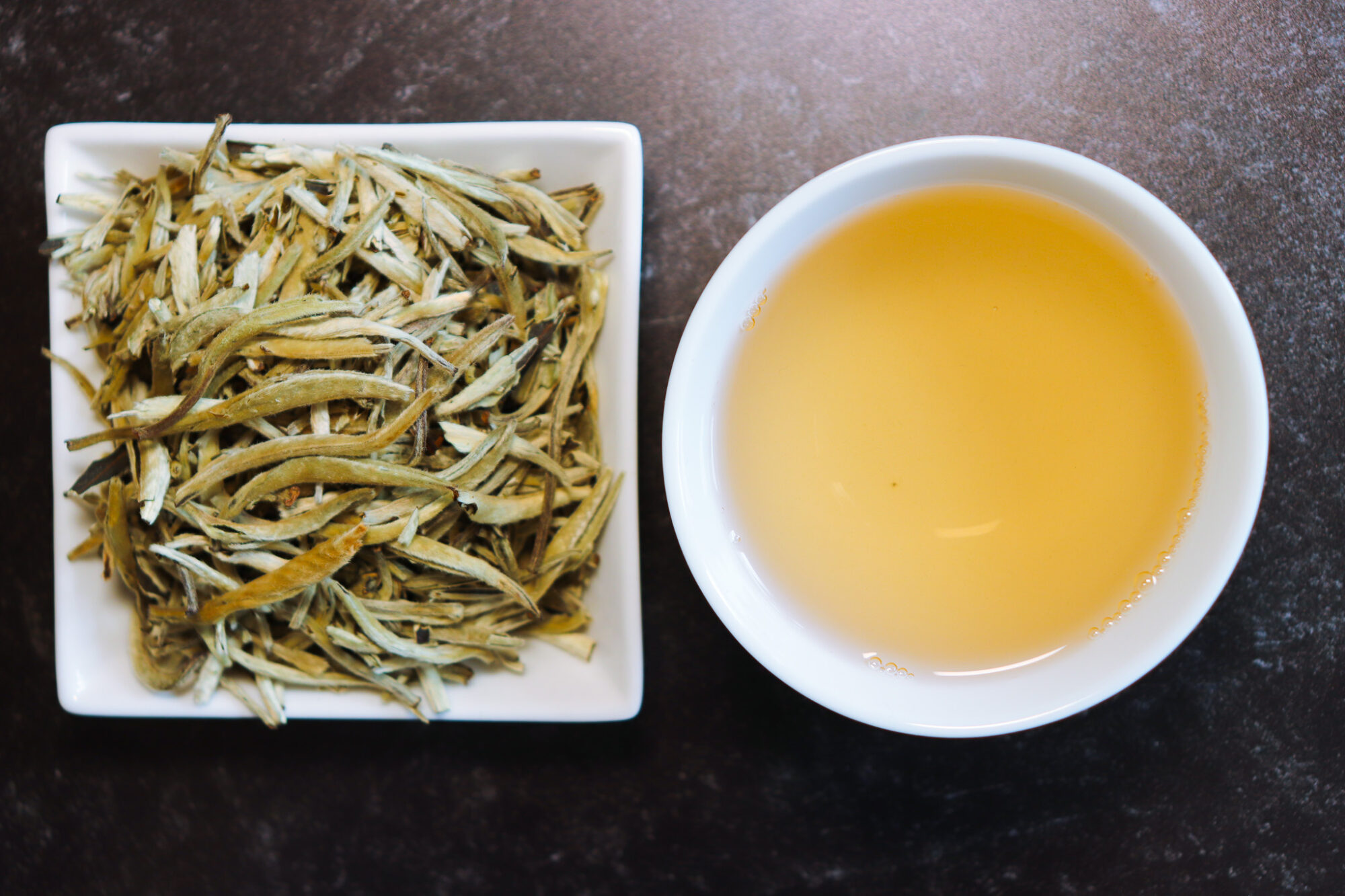 Art of Tea Organic Silver Needle White Tea &ndash; dry leaves alongside brewed tea